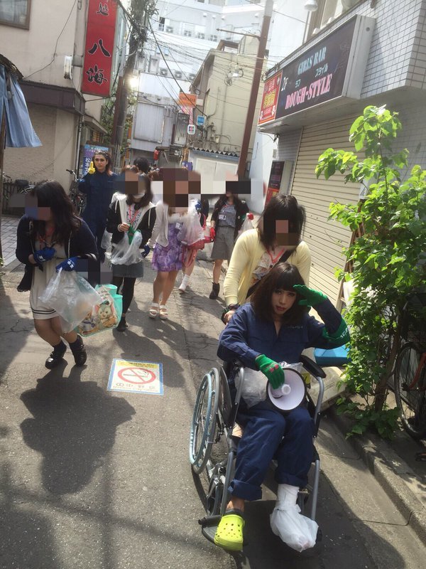 Izumi being pushed around on a wheelchair.